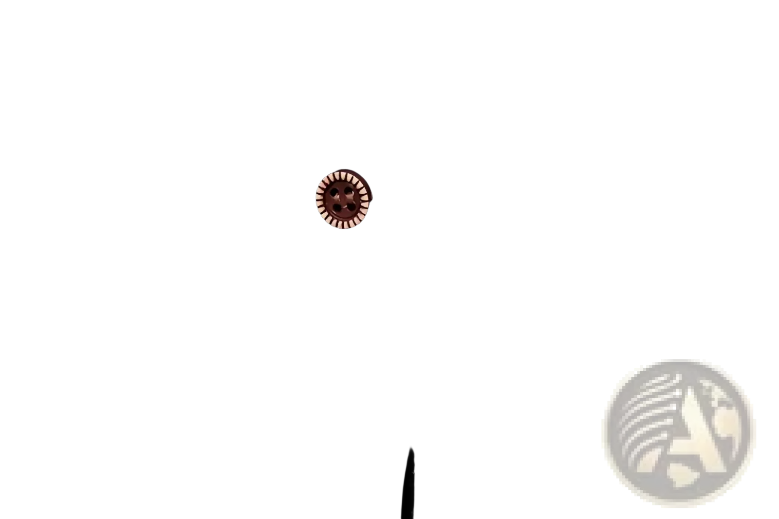 A rose-gold textured button with four dark holes on a men asymmetrical slant collar long sleeve casual shirt