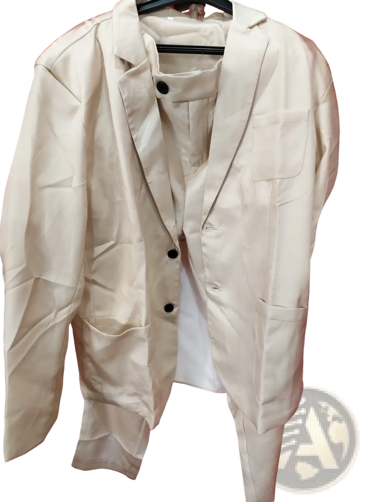 Men beige linen two piece suit blazer with black buttons and flap pockets hanging on a hanger