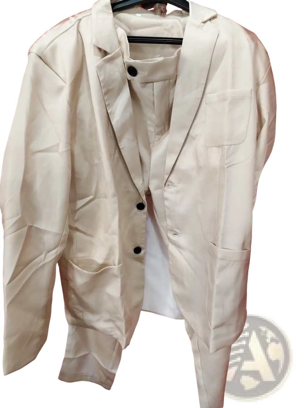 Men beige linen two piece suit blazer with black buttons and flap pockets hanging on a hanger