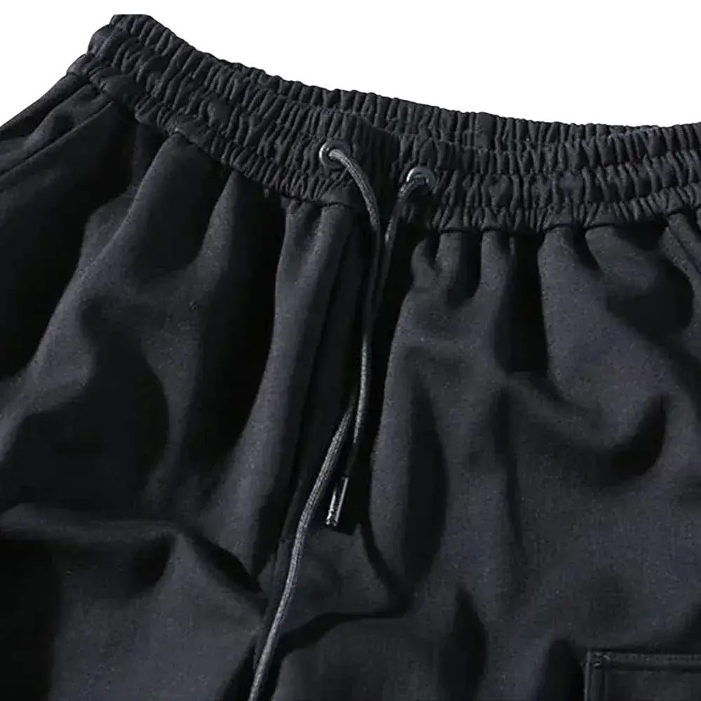 Men black cargo jogger pants featuring a soft textured fabric elastic waistband and multi pocket design for casual wear