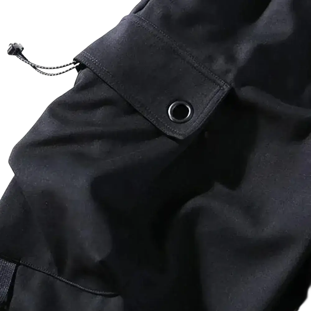 Men black cargo jogger pants made of durable fabric with reinforced stitching and metal grommet on pocket for casual wear