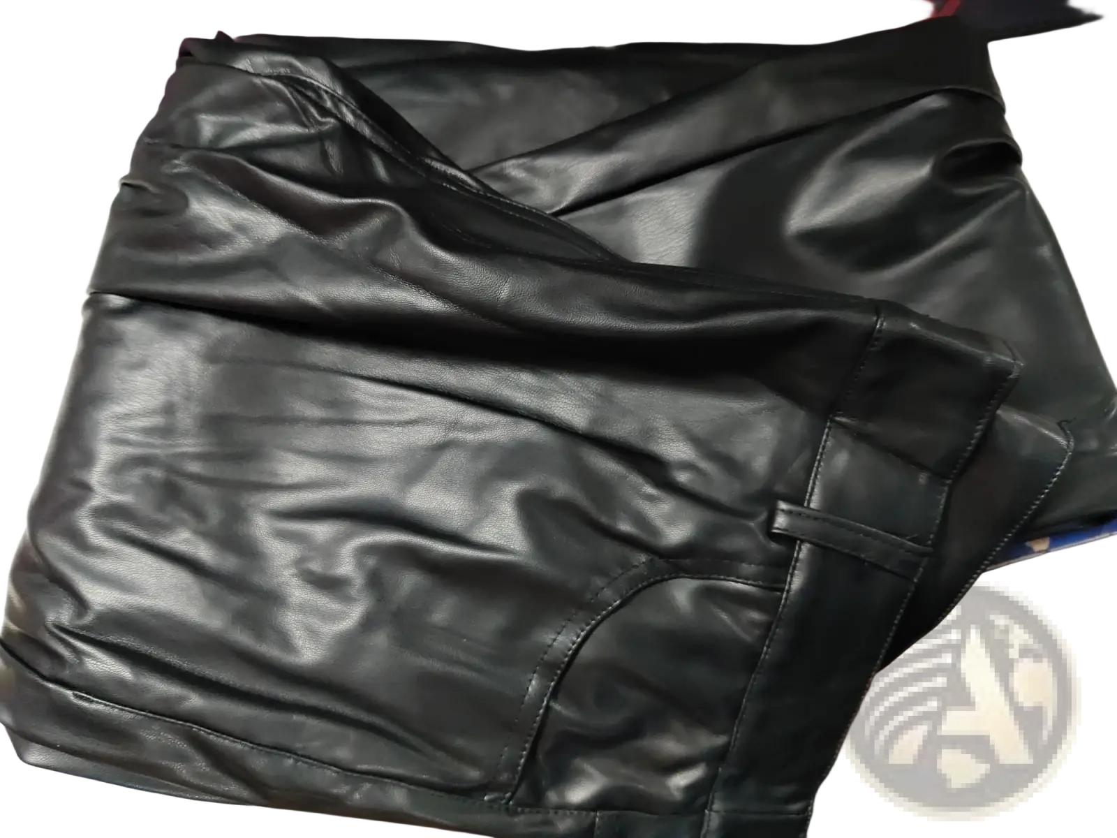 Men black faux leather pants with a smooth glossy finish and visible stitching along the seams in slim fit style