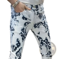 Men black floral slim fit jeans in white denim with bold black star and floral spray-paint pattern on front side