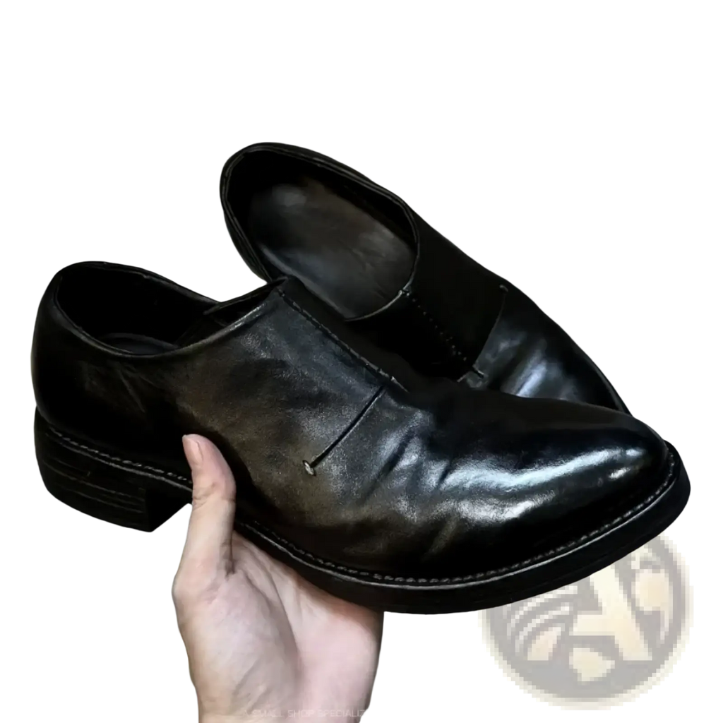 Men black leather vintage slip on dress shoes with polished finish and visible stitching