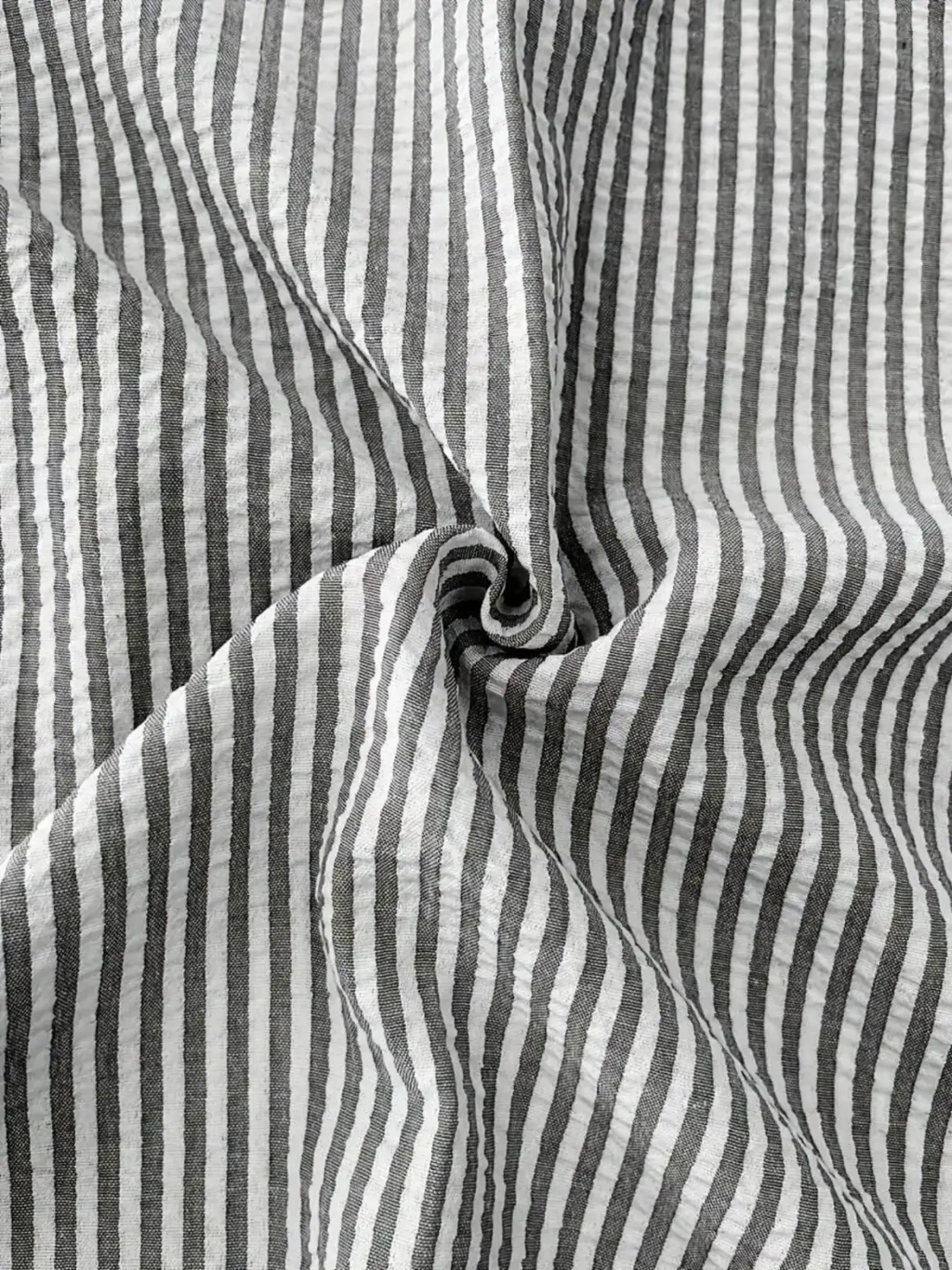 Men blue striped long sleeve casual button down shirt made of black and white vertically striped cotton fabric with subtle crinkles
