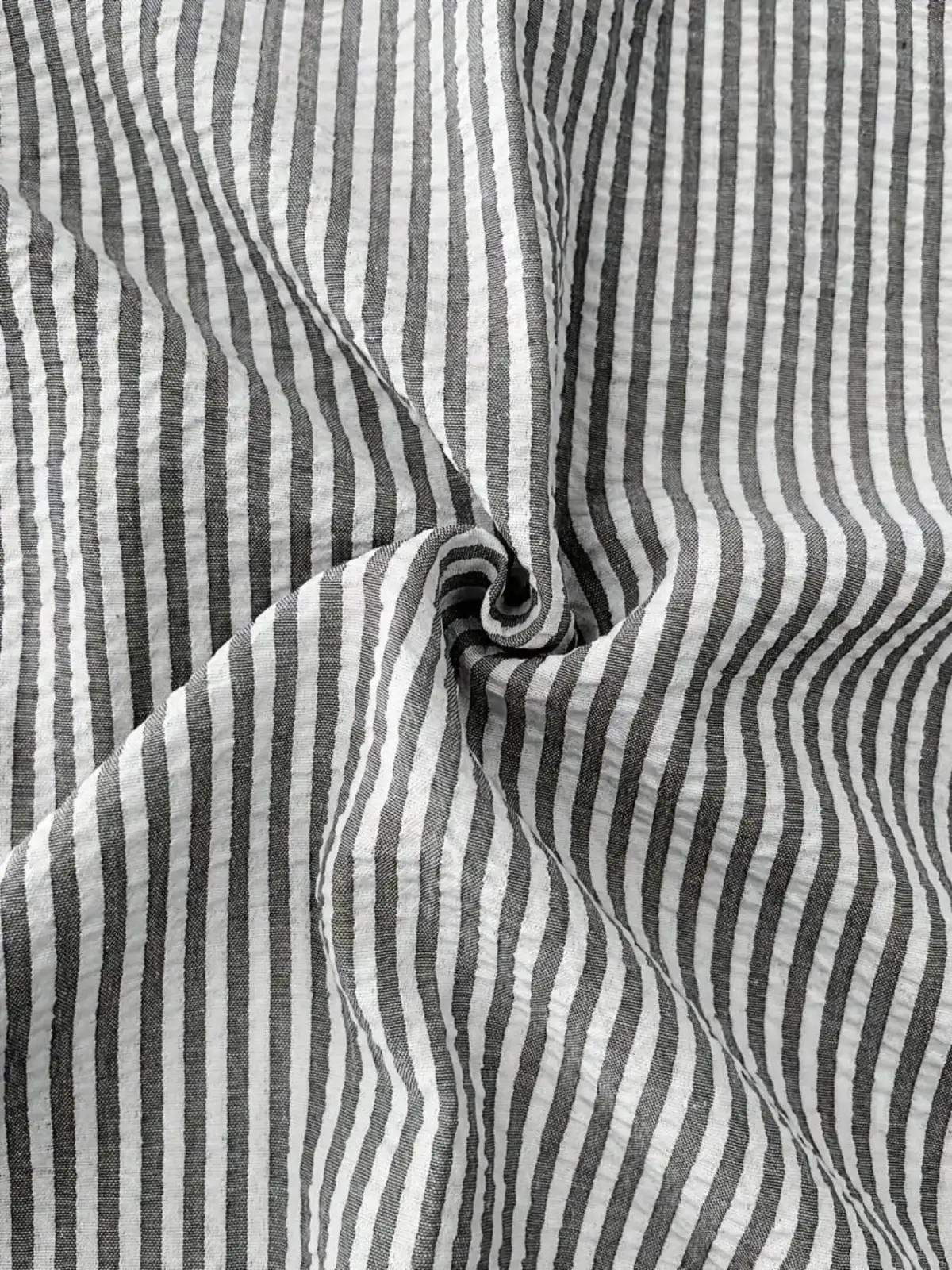 Men blue striped long sleeve casual button down shirt made of black and white vertically striped cotton fabric with subtle crinkles