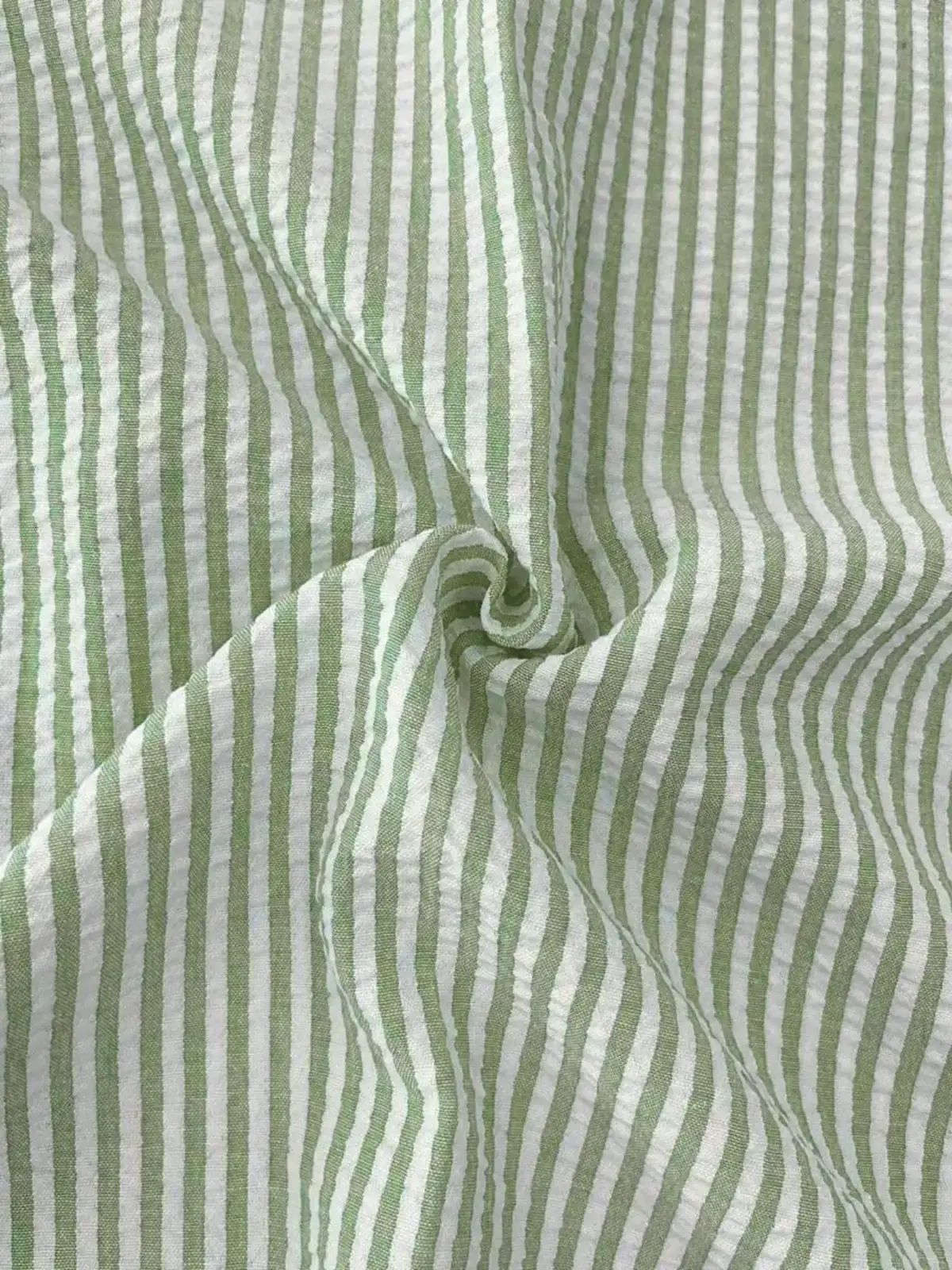 Men blue striped long sleeve casual button down shirt made of light green and white striped cotton with crinkled texture