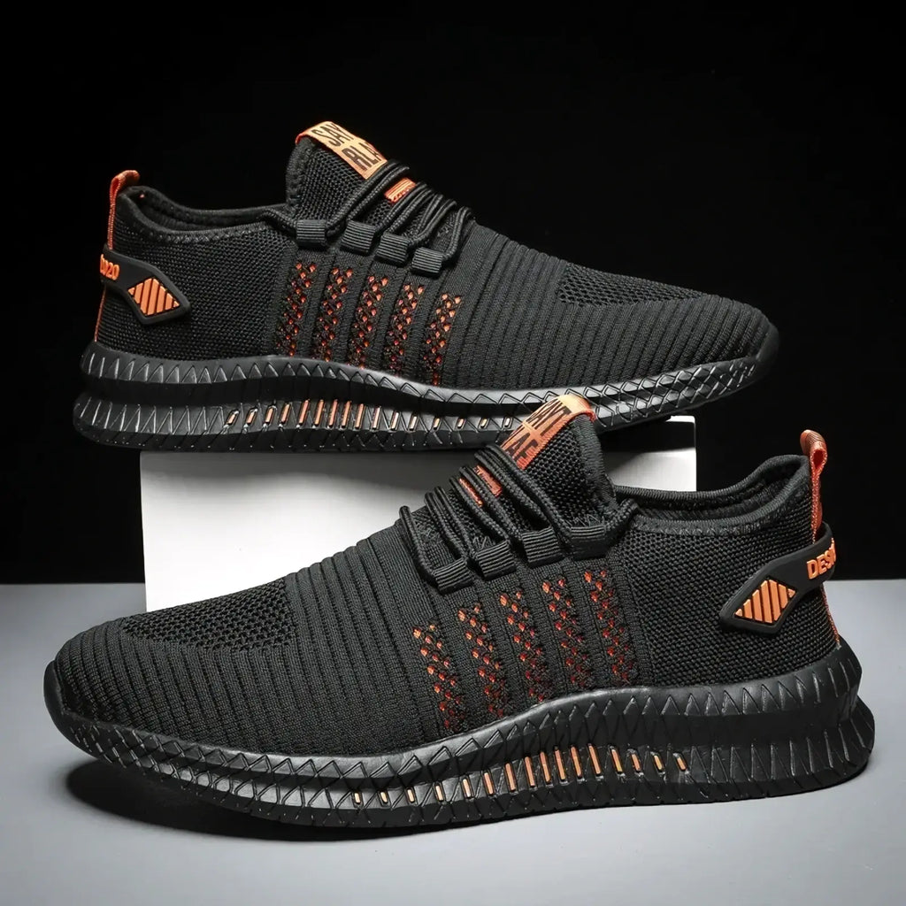 Men breathable casual knit sneakers in black and orange with textured mesh upper and bold red-orange accents