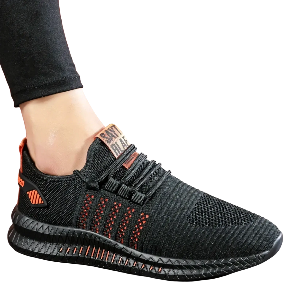 Men breathable casual knit sneakers featuring black knit material with orange accents and a textured sole