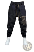 Men cargo joggers streetwear pants in black with beige drawstrings and bold white text graphic on the left leg
