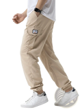 Beige men cargo sweatpants with relaxed fit, elastic cuffs, and branded patch on thigh pocket for casual hiking use