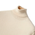 Cream-colored men cashmere turtleneck sweater with finely knit fabric and ribbed collar for a loose pullover fit