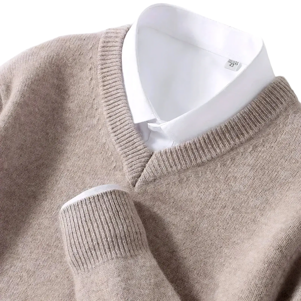 Beige men cashmere v neck pullover sweater with ribbed cuffs and neckline worn over a white collared shirt