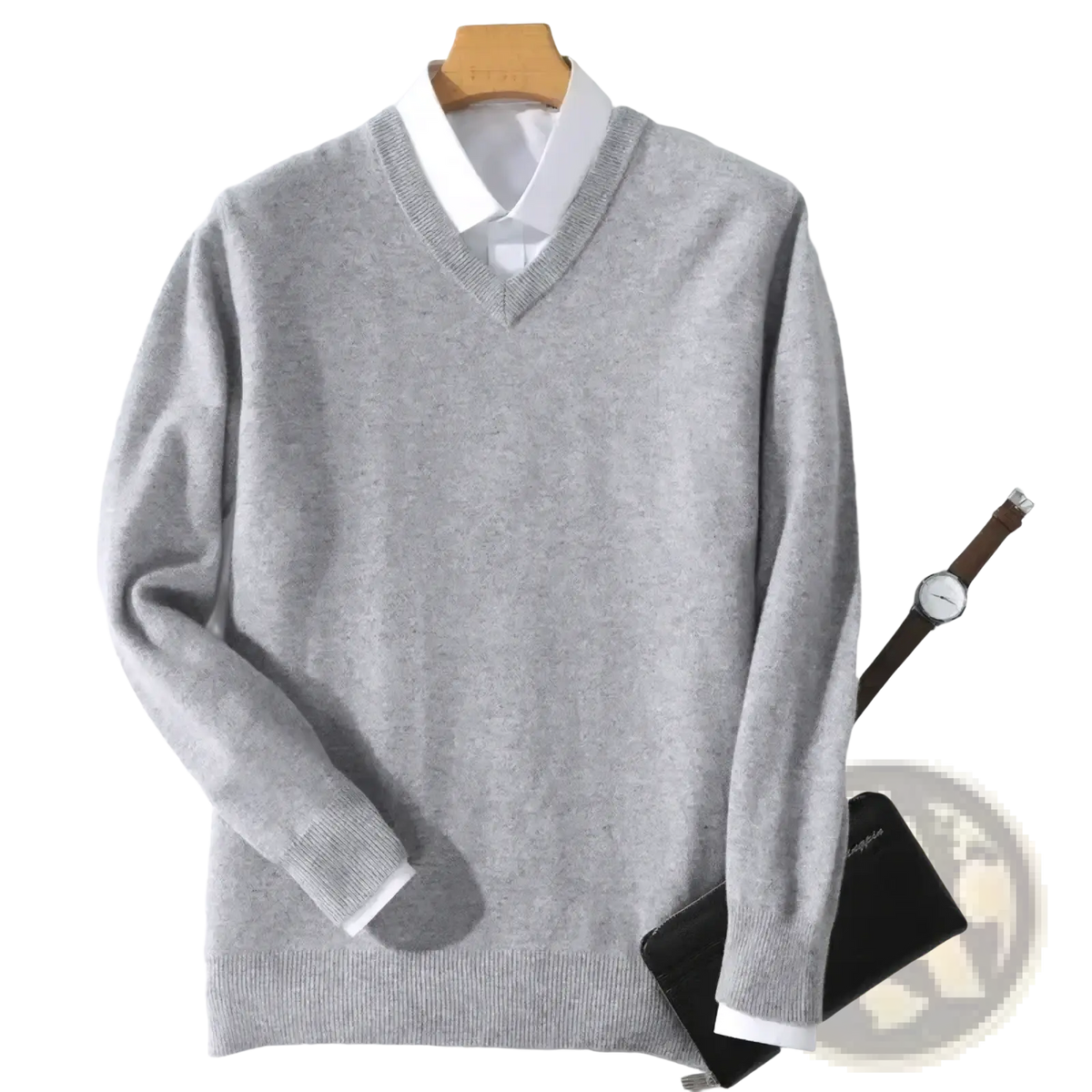 A soft heather gray men cashmere v neck pullover sweater with ribbed cuffs and hem hanging on a wooden hanger