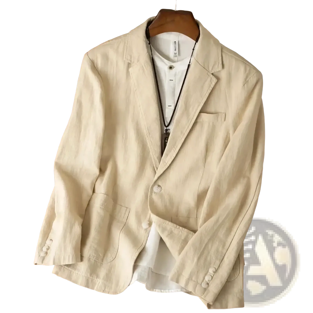 Beige cotton linen blazer jacket with relaxed fit and subtle texture worn over white button-up shirt for casual wear