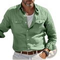A man wearing a light green linen long-sleeved men casual button up shirt with two chest pockets and white buttons