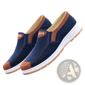 Men casual slip on canvas sneakers in navy blue with brown leather accents and white rubber soles for lightweight comfort