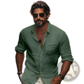 A man wearing a green linen men chinese collar casual long sleeve shirt with rolled sleeves and chest pocket