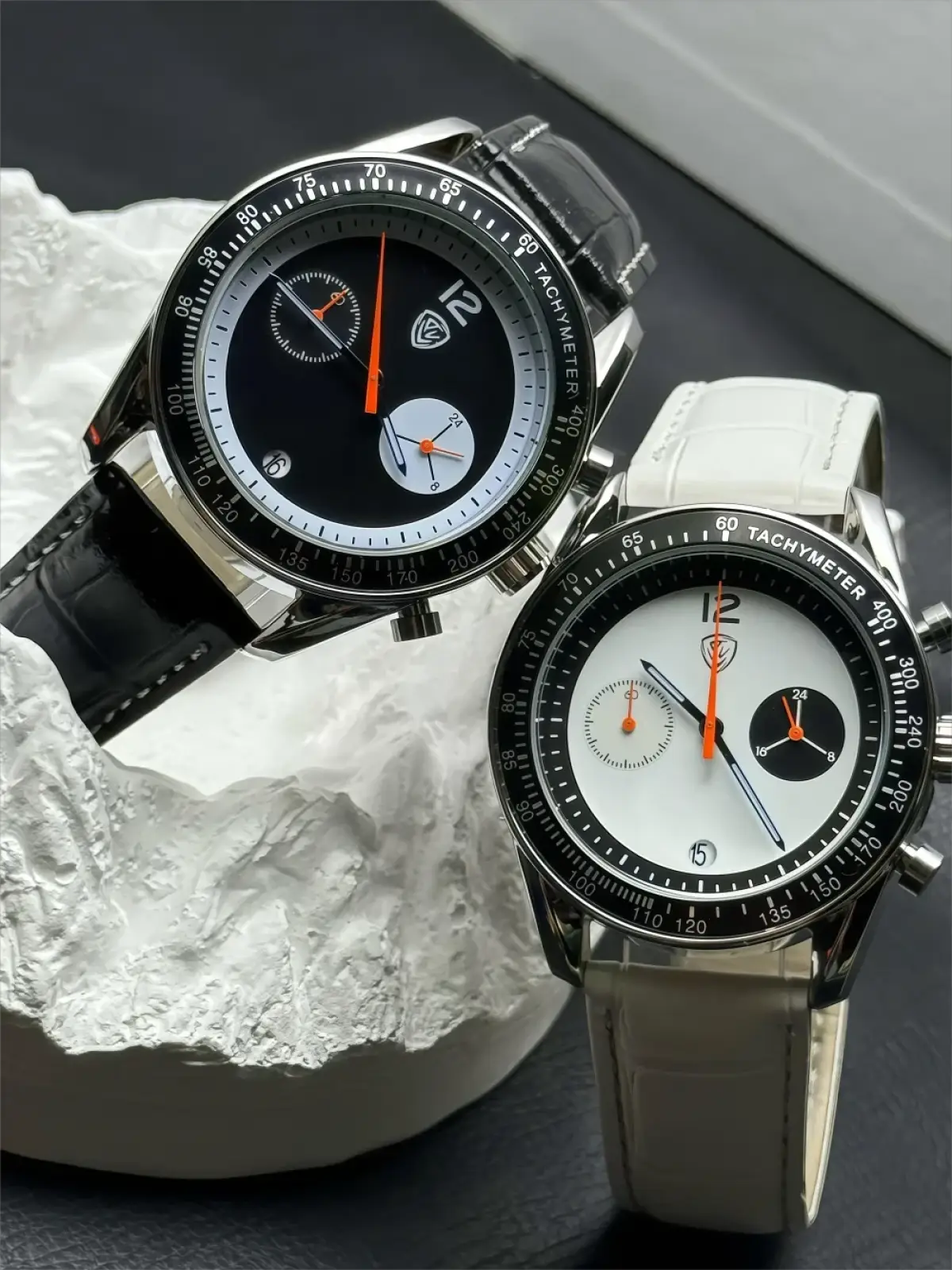 Men chronograph leather quartz watch with a sleek black and white dial, silver case, orange hands, and leather straps