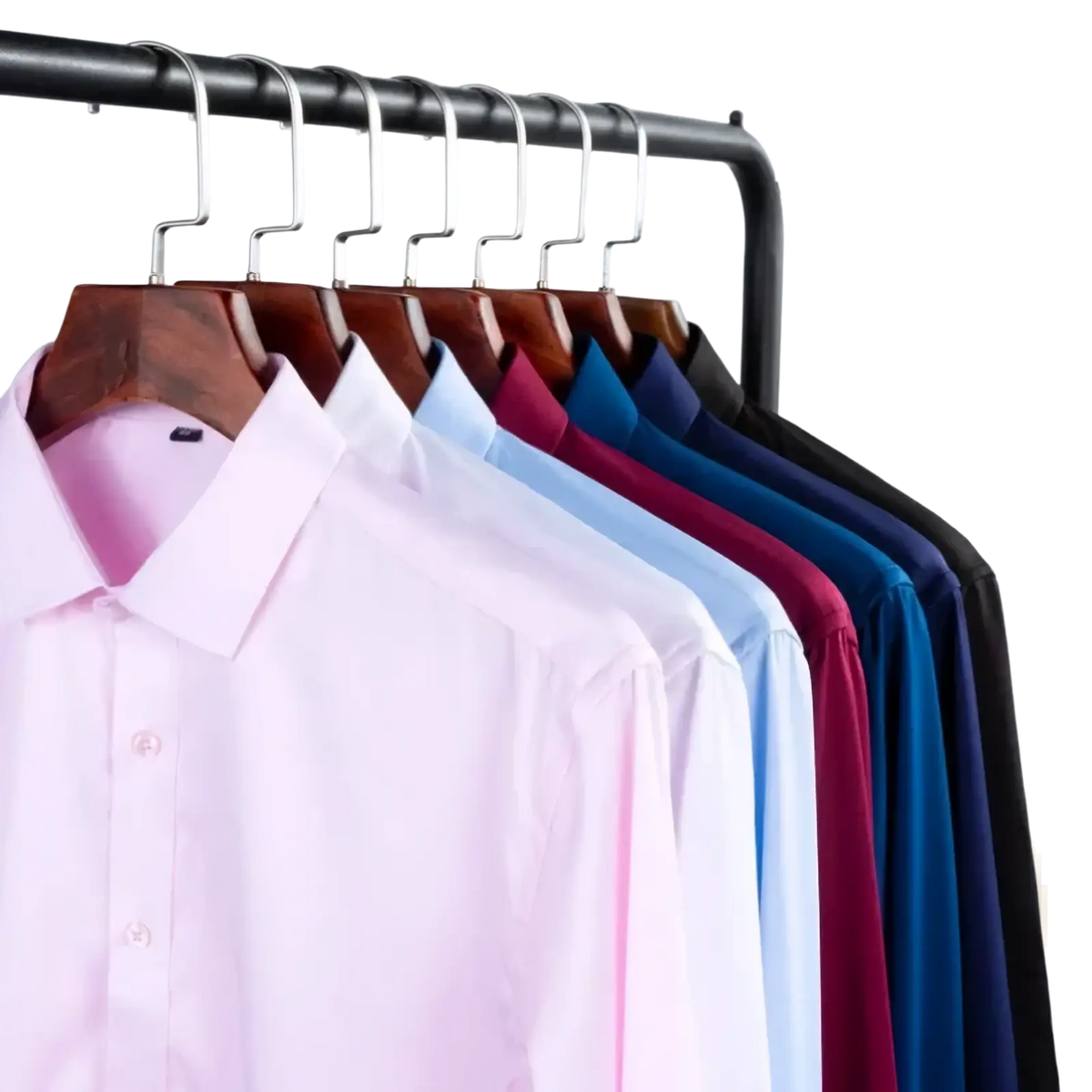A row of men classic long sleeve business dress shirts in soft pastel and solid colors on wooden hangers