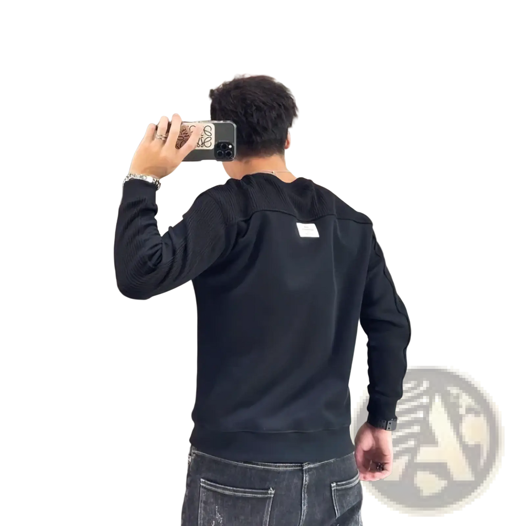 Back view of men colorblocked knit sweater with black ribbed knit fabric and white rectangular patch on sleeve panels