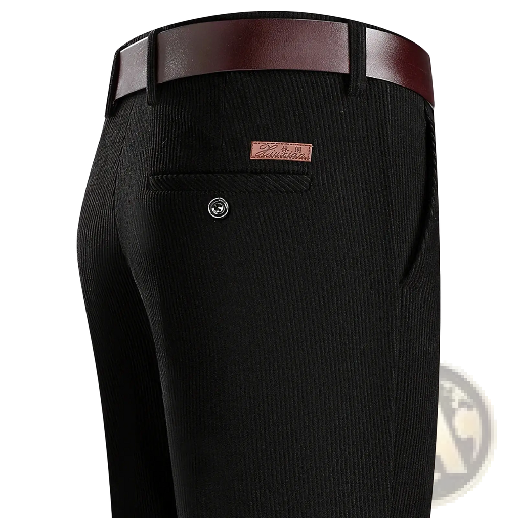 Men corduroy business casual pants in black with a brown leather belt and tan brand patch on the back pocket view