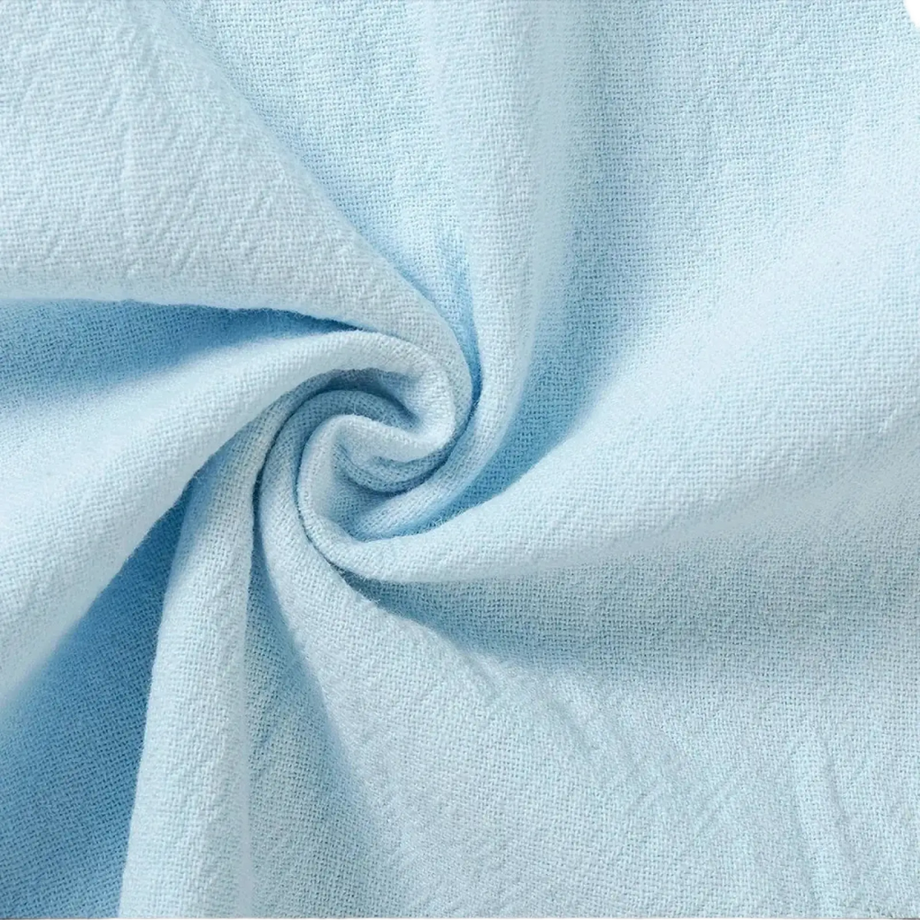 Light blue textured cotton linen trousers featuring a subtle woven pattern for breathable casual wear