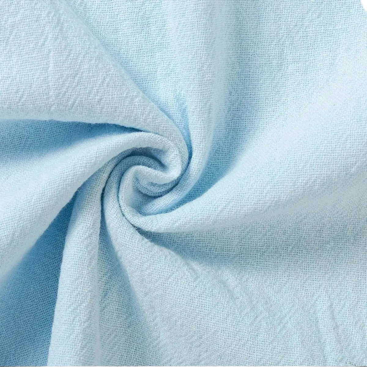 Light blue textured cotton linen trousers featuring a subtle woven pattern for breathable casual wear