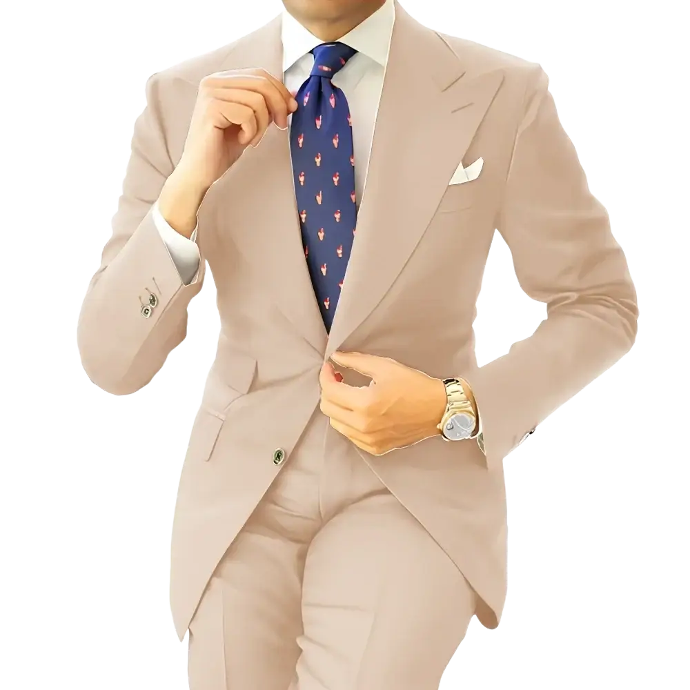 A man wearing a beige suit with a white shirt and navy tie with pink flamingos next to a men dark gray tailored tuxedo blazer jacket