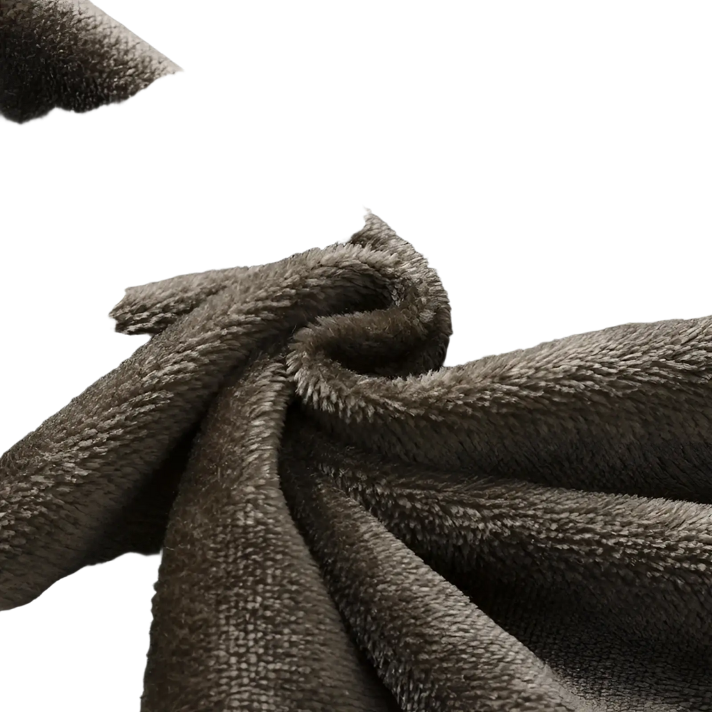 A plush dark gray fleece blanket with soft textured surface complementing men fleece lined baggy straight jeans