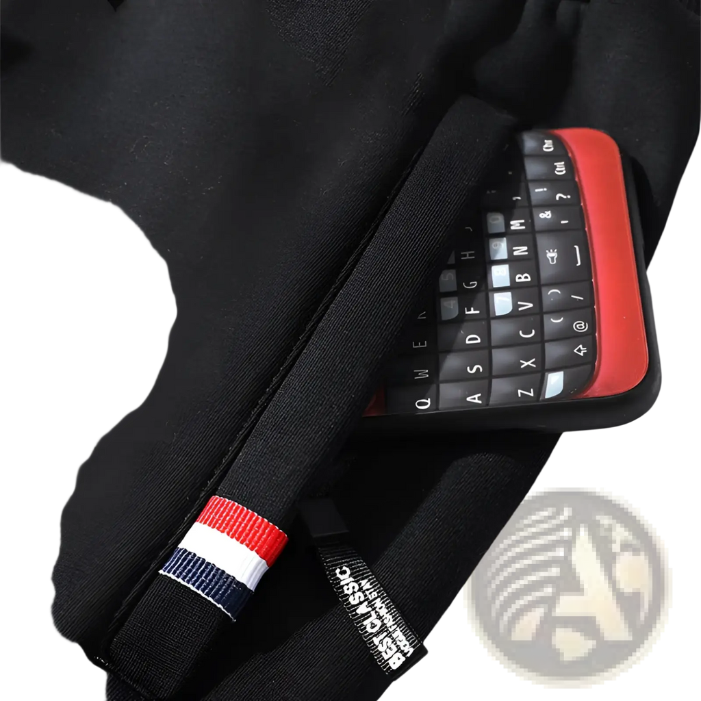 Men fleece lined joggers black cotton sweatpants with straight leg pocket holding black smartphone with red accent