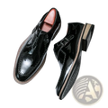 Men glossy patent leather dress shoes in black with a glossy finish and contrasting tan stitching along the edges