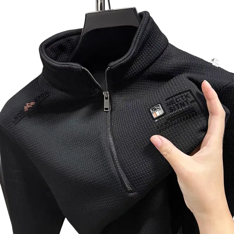 Black textured fleece hoodie offers a half-zip front with branded patches on the chest for retro casual outerwear