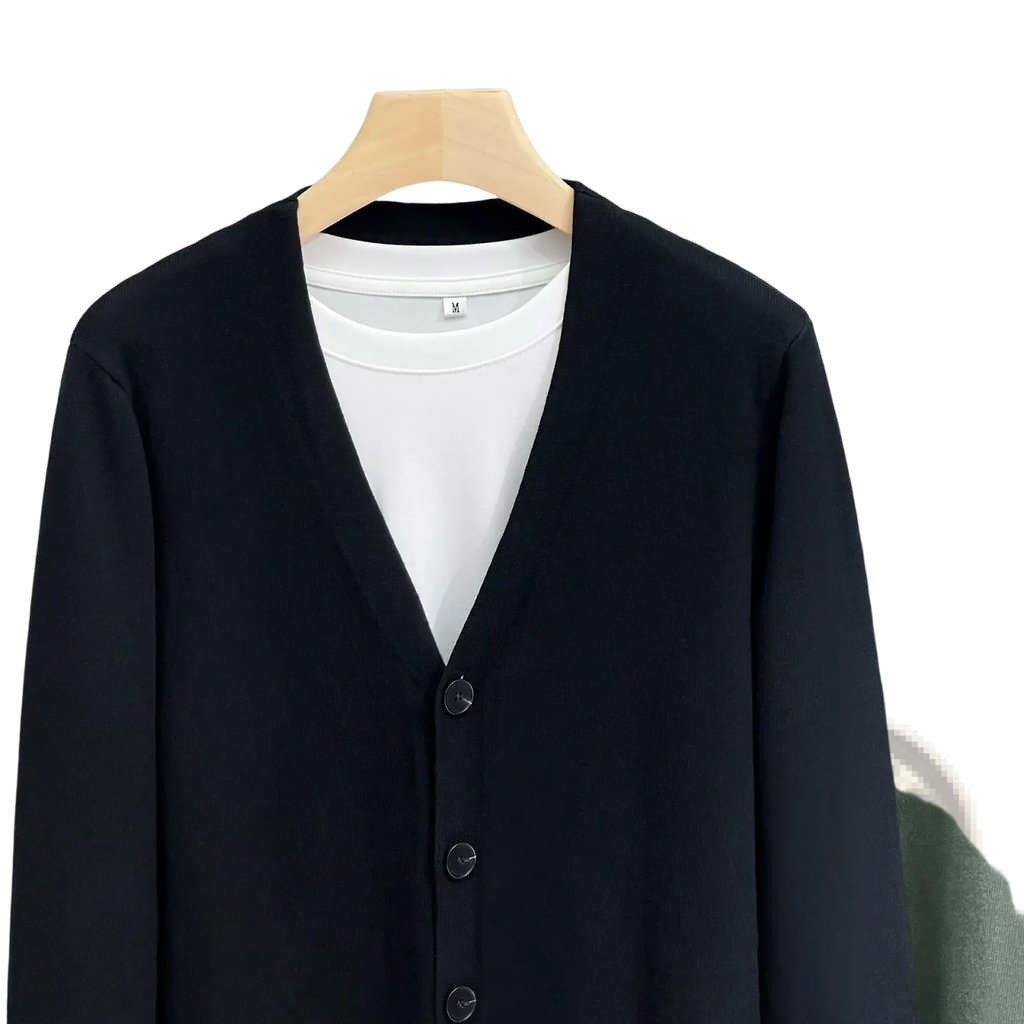 Men knitted vneck cardigan sweater coat in black with subtle texture and matching buttons worn over white crew neck tee