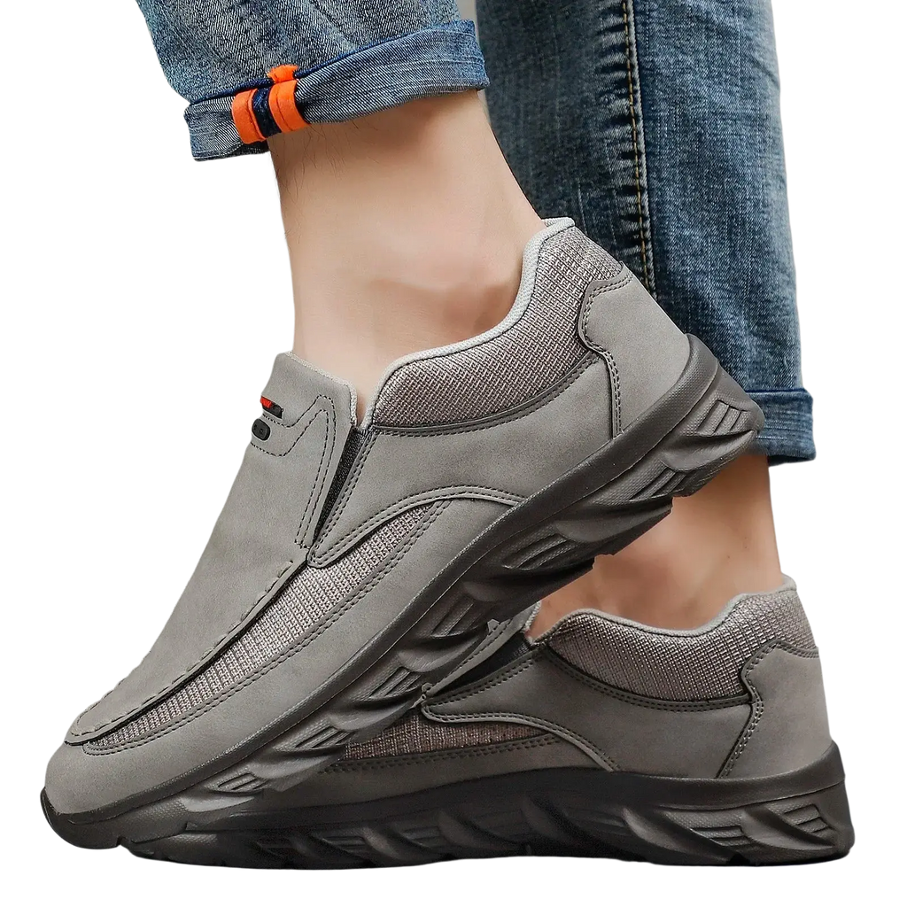 Men leather casual slip-on shoes in gray with textured upper black rubber sole and orange accent on the cuff