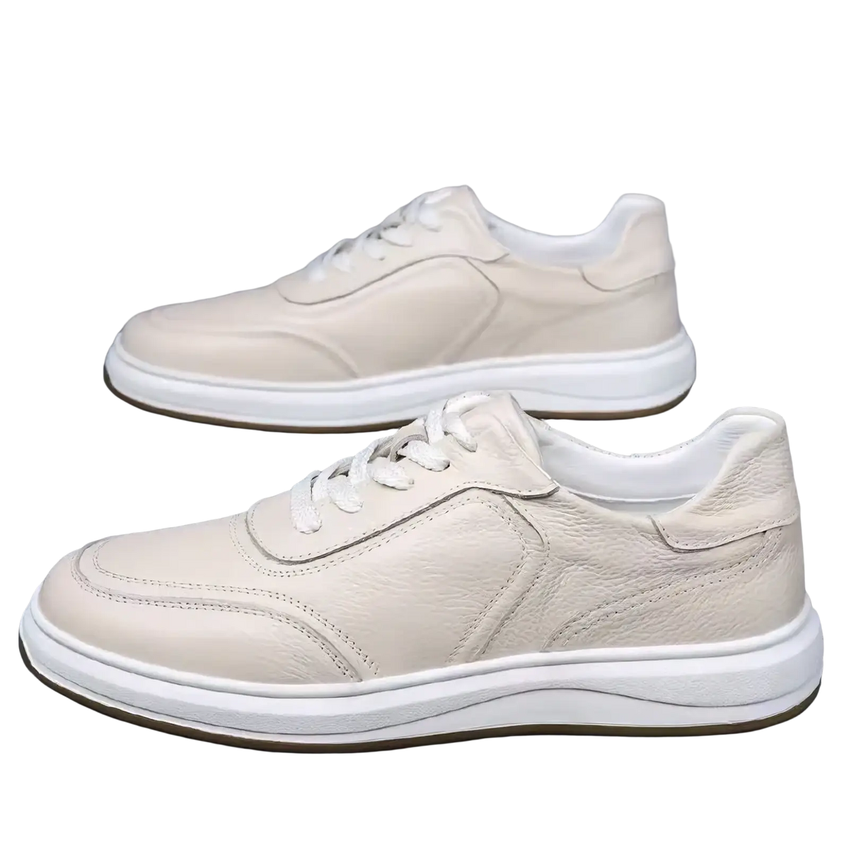 Cream-colored men leather casual slip-on sneakers with white laces and a thick cushioned sole for everyday wear