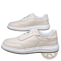 Cream-colored men leather casual slip-on sneakers with white laces and a thick cushioned sole for everyday wear