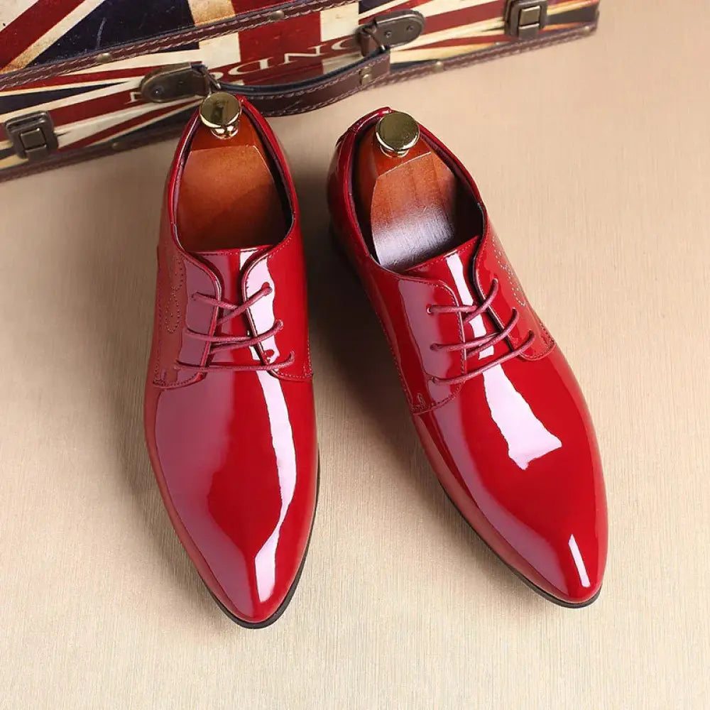 Men’s premium leather dress shoes in shiny red patent leather with pointed toes and lace-up design