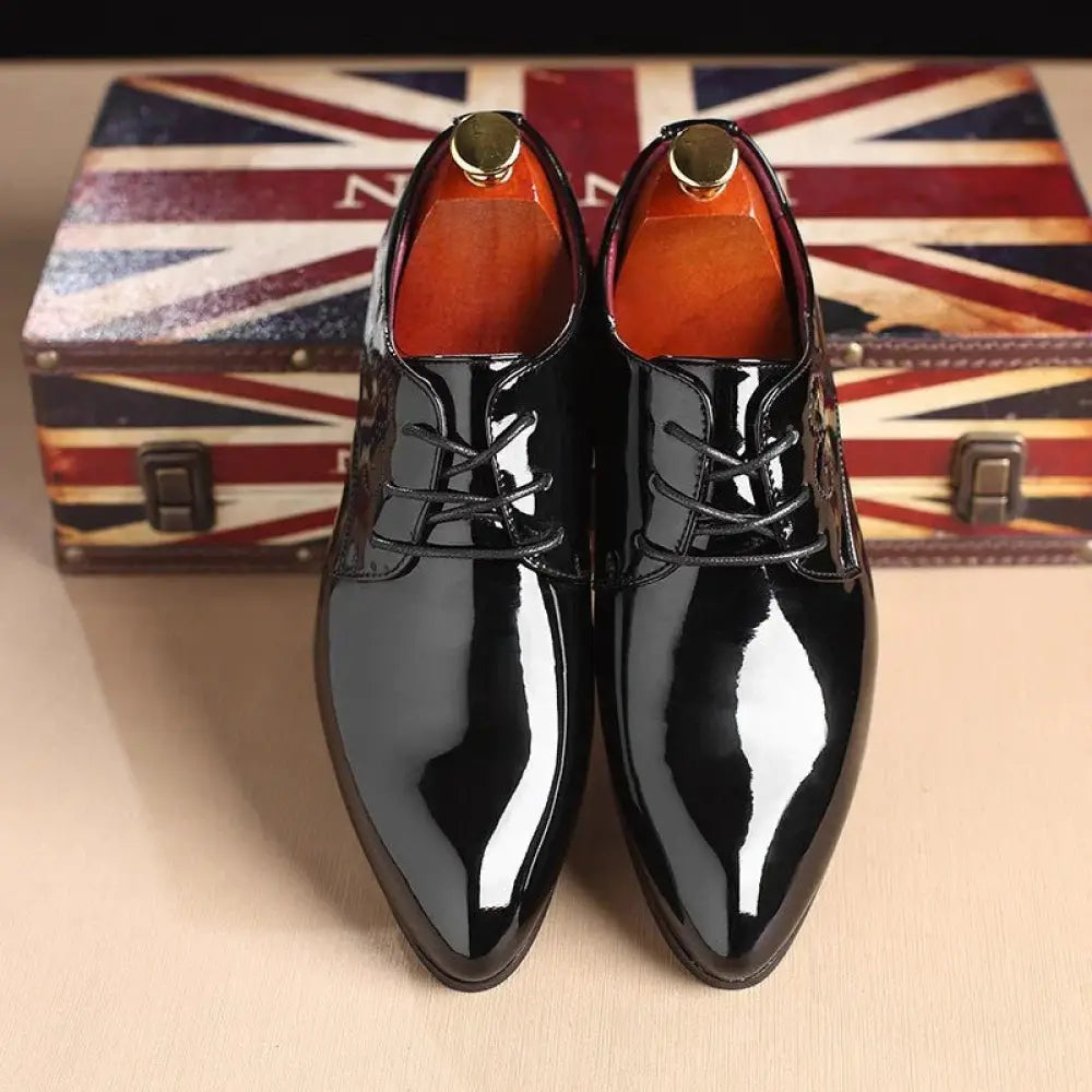Men’s premium leather slip-on driving loafers in shiny black patent leather with pointed toes and gold-colored shoe trees