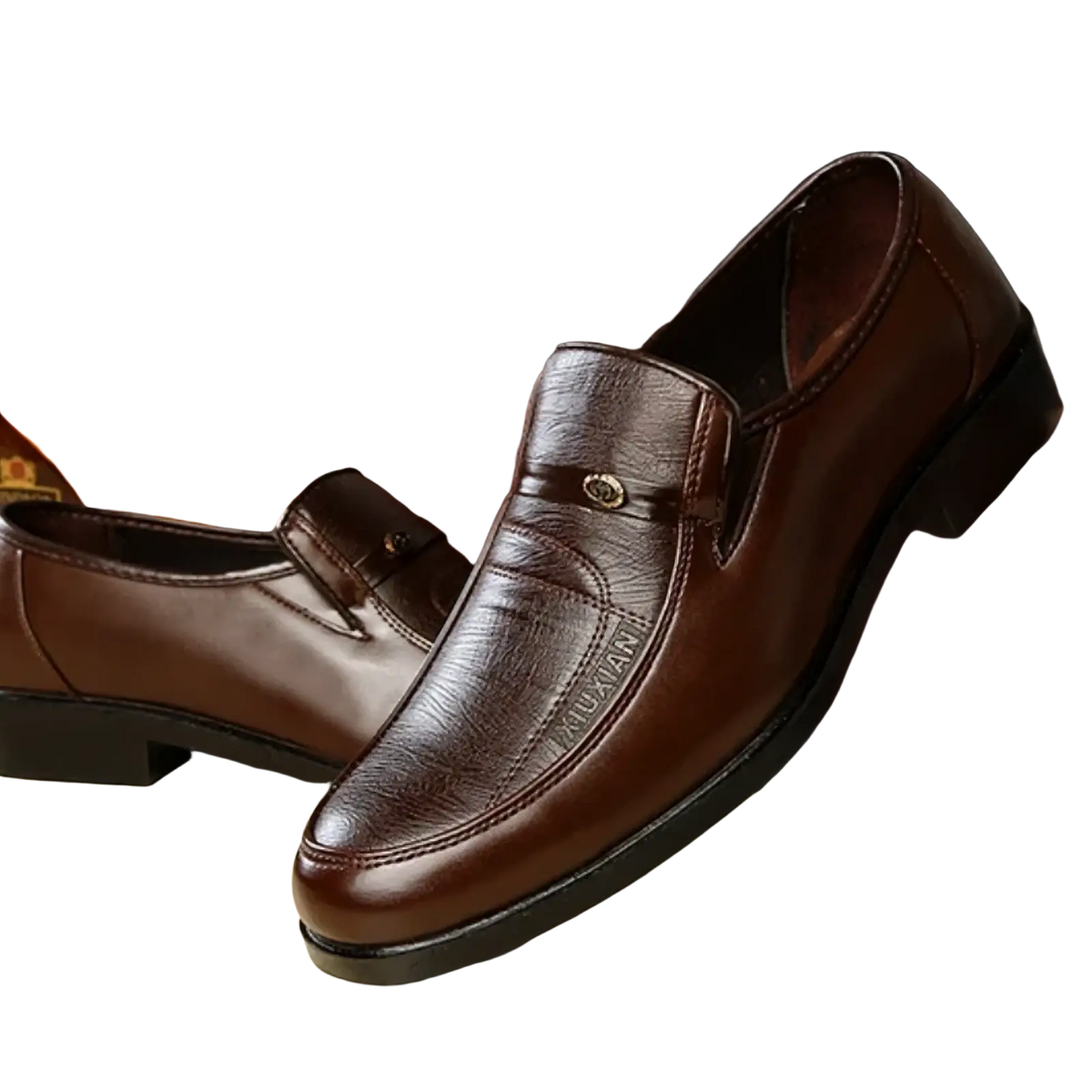 Men leather slip on dress shoes in brown with subtle textured pattern and small metallic emblem on the vamp