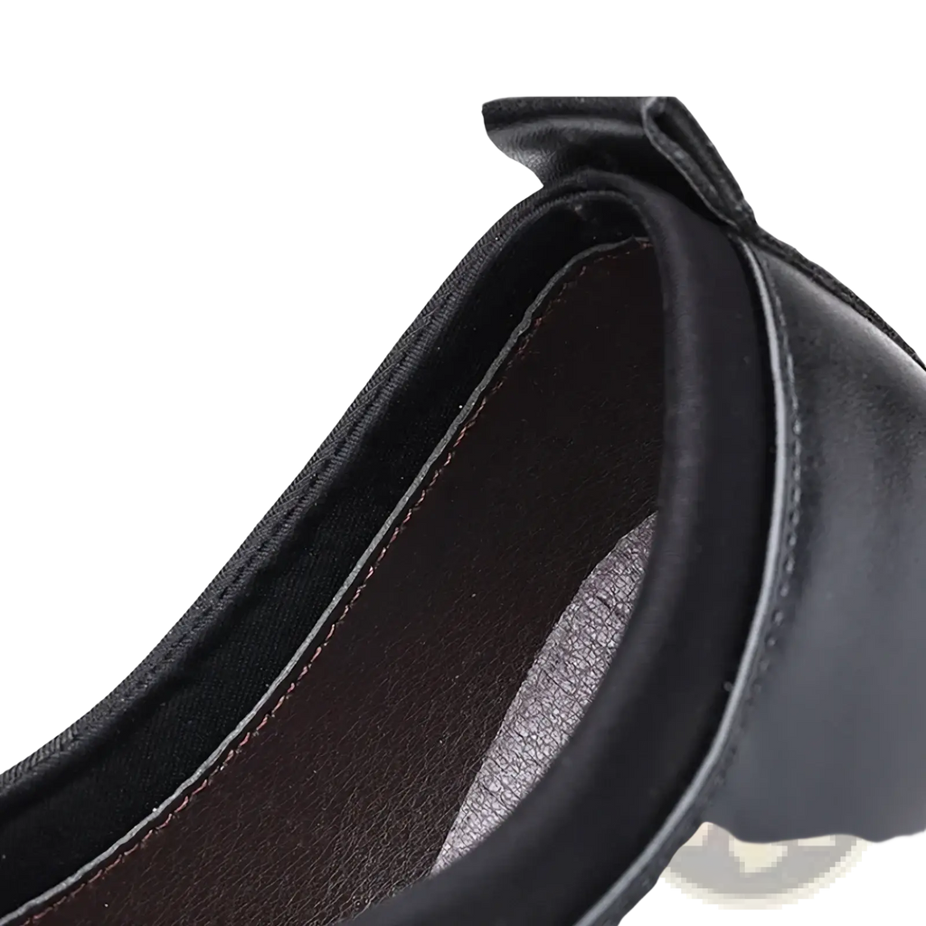 Black leather slip on dress shoe with smooth polished finish and contrasting brown lining for formal use