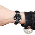 Men leather strap quartz wristwatch with black leather band, silver-toned case, and black dial with white arabic numerals