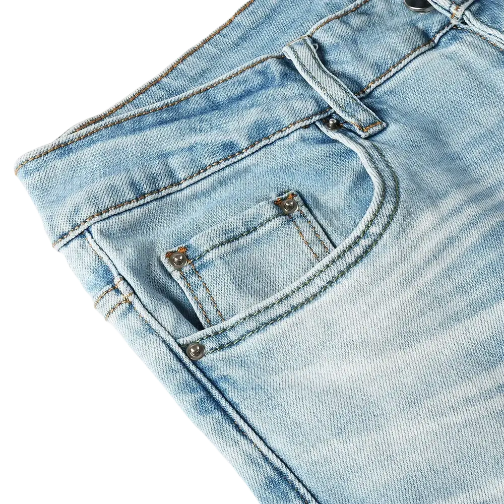 Men light blue bootcut jeans made of denim with sturdy stitching metallic button fastenings and a frayed hem