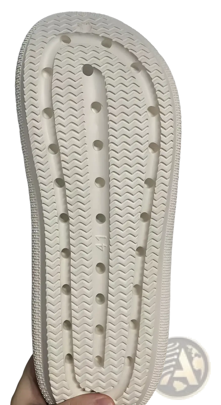 White rubber sole with textured wavy pattern and circular indentations on men lightweight mesh clog slippers with adjustable straps