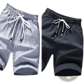 Men linen boxer shorts casual loose summer beach wear in gray and black with white drawstring cords and lightweight fabric