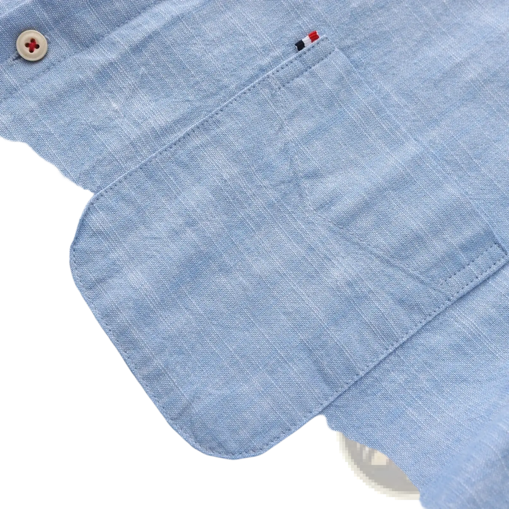 Men linen cotton casual long sleeve shirt in light blue chambray with a textured weave chest pocket and beige button detail