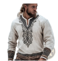 A man wearing a cream-colored men linen digital print short sleeve t-shirt with black embroidered patterns on the neckline and cuffs