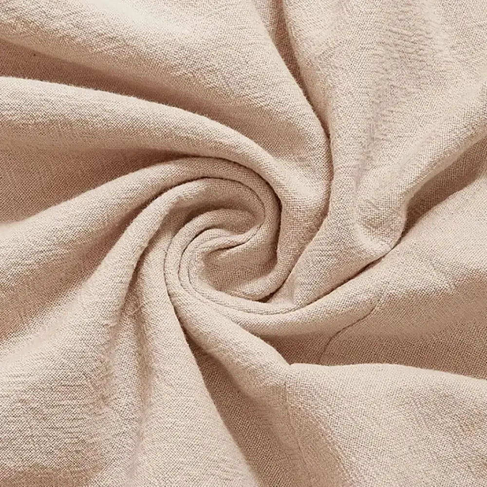 Beige linen harem pants made of soft textured linen fabric with a loose fit and gentle folds for comfortable wear