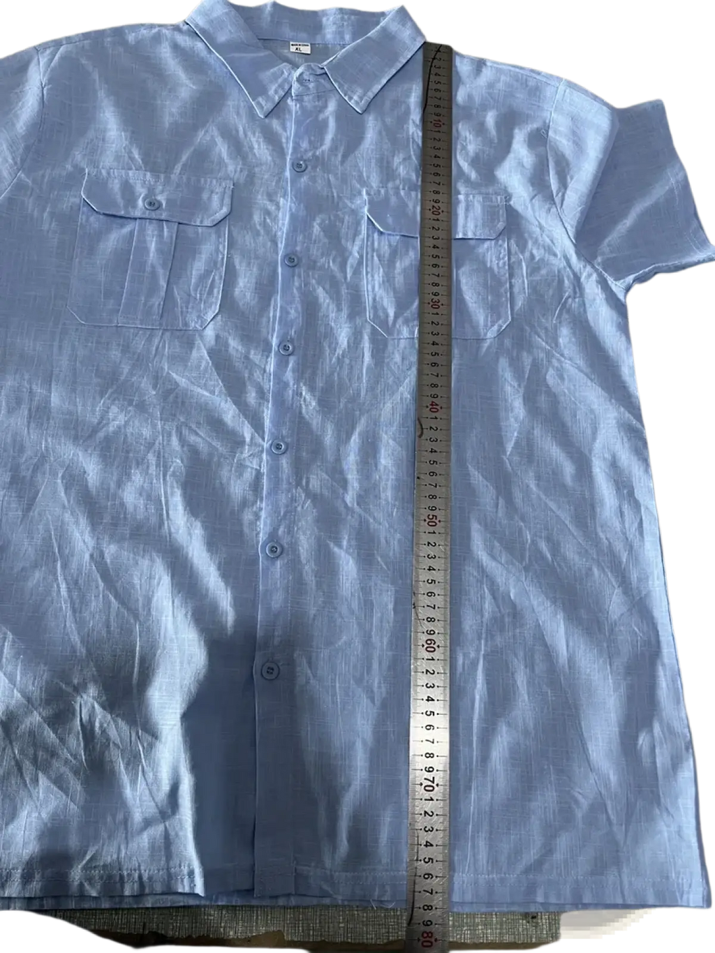 Light blue linen men short sleeve button-up shirt with double chest pockets and collar for casual summer wear