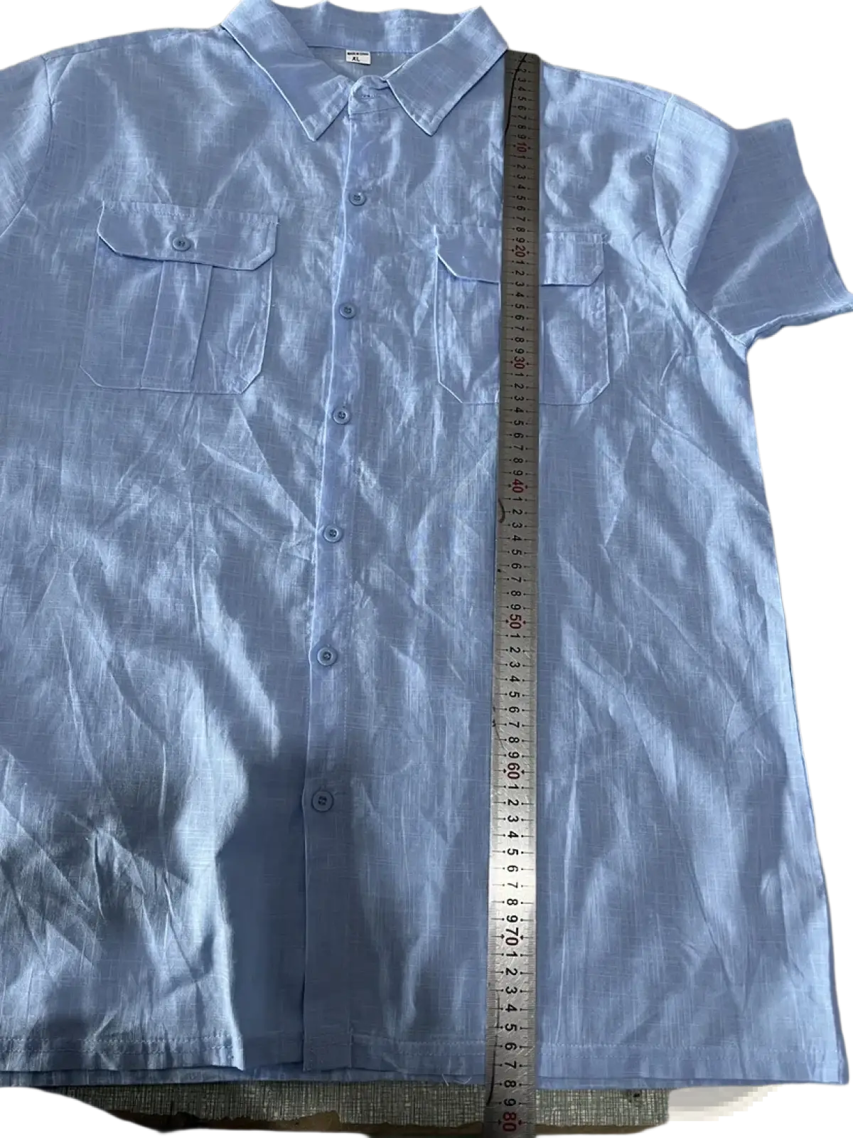 Light blue linen men short sleeve button-up shirt with double chest pockets and collar for casual summer wear